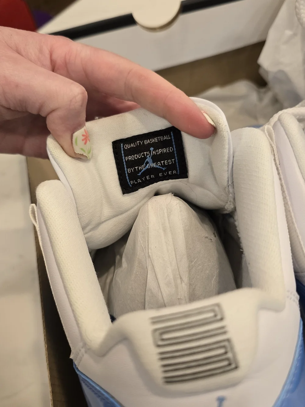 Air Jordan 11 Low Retro White and University Blue Sneakers